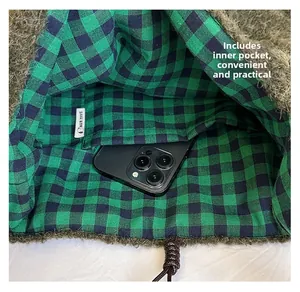 Detail view of the green fuzzy bag interior with a checkerboard liner and phone pocket
