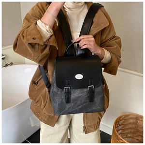 Details des grauen Vintage-Rucksacks mit Marmortextur, Metall-Hasenlogo und schwarzen Gurten