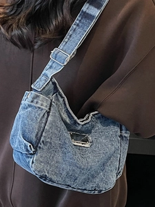 Vintage blue denim crossbody bag with adjustable strap and washed retro texture