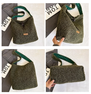 Detail of army green plush tote bag featuring a green checkered strap and brown logo patch