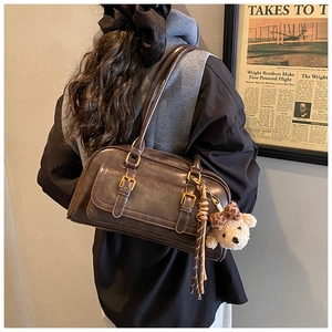 Detailed back view of vintage brown PU leather shoulder bag with plush bear charm