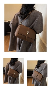 Detail view of deep coffee lychee leather shoulder bag with gold buckle and strap