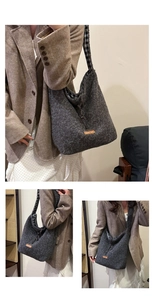 Detail view of large grey felt hobo bag with grid lining and stylish orange brand label