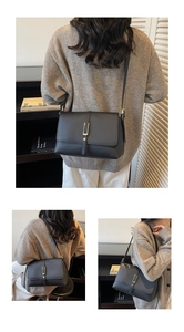 Detailed view of black litchi texture leather small square bag with gold U-shaped metal buckle