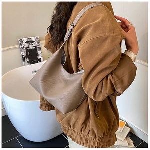 Detail of taupe litchi grain leather hobo bag showing high-quality texture and strap