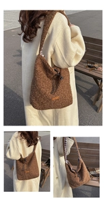 Close-up of brown plush tote bag with drawstring closure and orange leather logo label