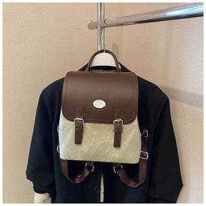 Detail eines Vintage-Canvas-Rucksacks mit brauner Lederklappe und süßem Hasen-Logo