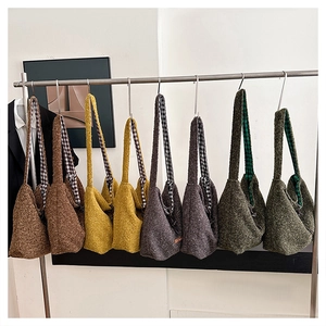Detail of plush crossbody bags in various colors with stylish checkered strap lining