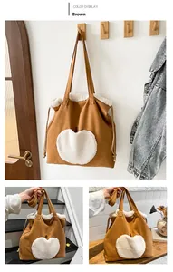 Dettaglio della borsa tote in pelle scamosciata marrone con ricamo a mela di peluche