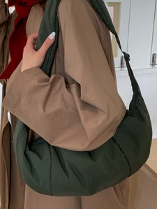 Deep green quilted nylon crescent bag with wide strap for autumn fashion style