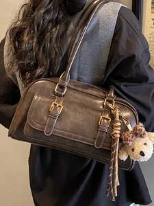 Deep brown retro Boston shoulder bag with dual gold buckles and a cute teddy bear charm