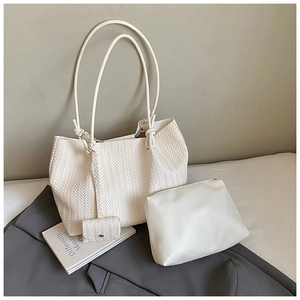 Three-piece set featuring white woven tote bag with matching pouch and clutch