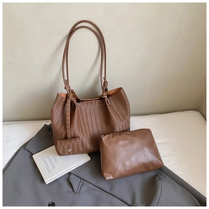 Detail view of the brown woven tote bag set including a small coin purse and inner pouch