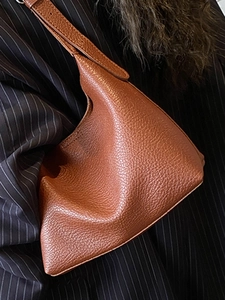 Minimalist brown pebbled leather bucket bag for women, stylish commuting shoulder bag style