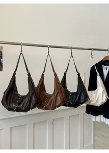 Detail view of retro tote bags with star rivets in brown, black, and beige colors