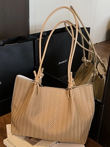 Chic woven tote bag in camel brown with stylish knotted handles for daily commute