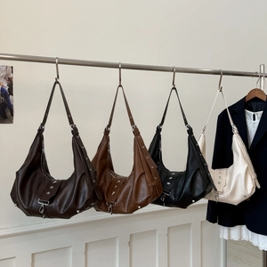 Detail view of vintage hobo bags with star rivets and adjustable straps in four colors