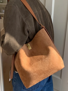 Brown suede bucket tote bag with gold swivel lock and adjustable strap for women