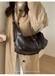 Detail of dark brown retro tote bag with silver star rivets and premium soft leather