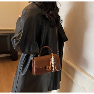 Brown vintage leather handbag with ethnic colorful wooden bead tassel details
