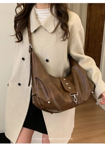 Detail of retro brown tote bag with star rivets and minimalist sophisticated vibe