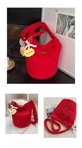 Close-up of red plush bucket bag with yellow cloud pendant and branded leather label