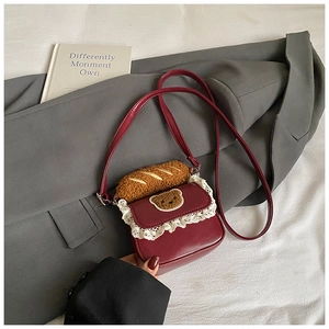 Detail of burgundy PU leather mini bag with lace trim and plush bear decoration