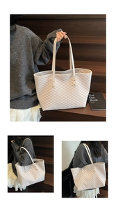 Detailed close-up showing the elegant letter monogram pattern and large capacity tote bag