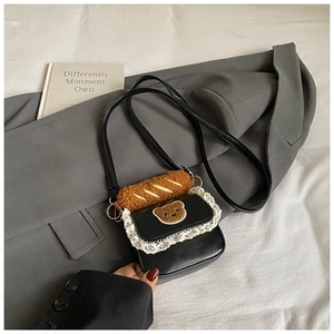 Mini black handbag with white lace trim, cute bear patch, and plush baguette charm detail
