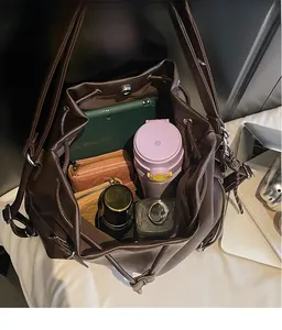 Top view of large capacity dark brown bucket bag showing interior space for tablet and items