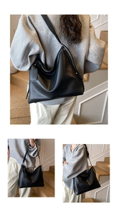 Detail of black large capacity leather tote bag showing soft lychee grain texture and tag
