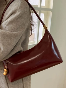 Retro burgundy patent leather underarm shoulder bag with gold hardware and logo detail