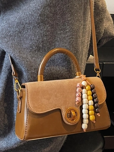 Brown vintage handbag with matte suede panel and gold turn-lock closure for women
