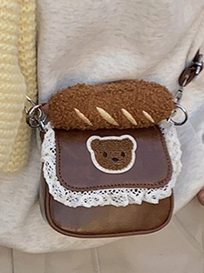Brown mini crossbody bag with white lace trim and cute teddy bear patch on the flap