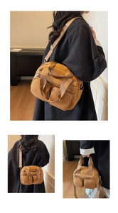 Close-up of the khaki nylon crossbody bag showing multiple pockets and durable zippers