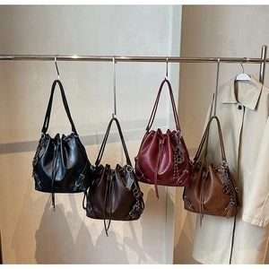 Detailed display of four leather drawstring bucket bags in black, coffee, red, and brown