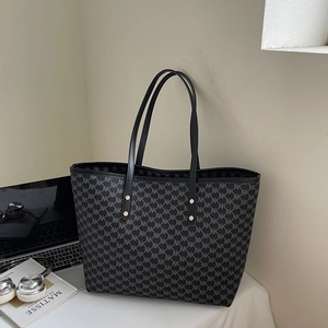 Detailed view of the black monogram tote bag with spacious interior and laptop essentials