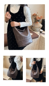 Detail view of large dark brown leather hobo bag with pebble texture and adjustable strap