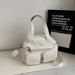 Detail of white nylon crossbody bag with functional square pockets and adjustable strap