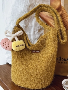 Mustard yellow plush knit bucket bag with cute cherry charms and leather brand label