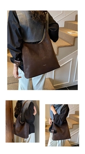Macro view of dark brown PU leather tote bag with embossed fashion branding and wide strap