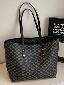 Minimalist large tote bag with repetitive NK letter print and gold rivet handles