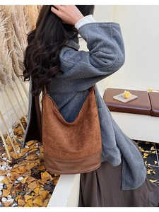 Detail view of large brown shoulder bag with mixed suede and smooth leather textures