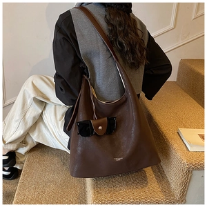 Close-up of large coffee brown hobo tote bag with Moier & Bags logo and sunglasses