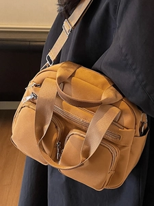 Minimalist ginger yellow nylon crossbody bag with multi-pocket design and adjustable strap