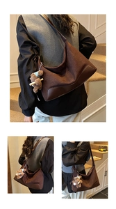 Deep brown suede crossbody bag with leather corners and a cute bear plush pendant charm