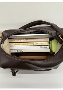 Macro view of spacious dark brown leather tote interior with tablet and daily essentials