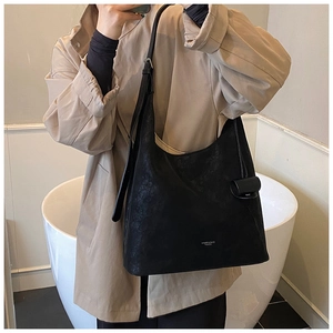 Detail view of a large black matte tote bag featuring the Higher Bags Fashion white logo