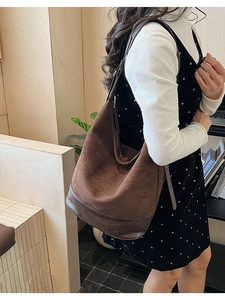 Detail view of large coffee brown suede tote bag showing texture and adjustable strap