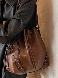 Vintage brown leather drawstring bucket bag with decorative woven strap for women